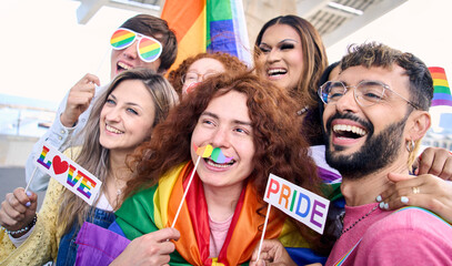 Group cheerful young friends taking fun selfie for social media celebrating gay pride day outdoors....