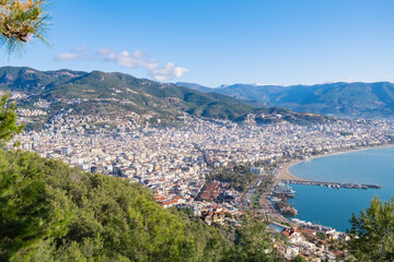 Fototapeta na wymiar Panoramic view of the seaside town with the port. View from the mountain on a clear summer day to the resort town.