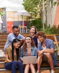 Students, laughing and laptop with funny joke on campus, break and internet for online meme. Friends, diversity and people at university for social media and discussion of comedy topic in college