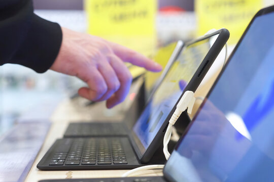 Buyer checking laptops in a computer store