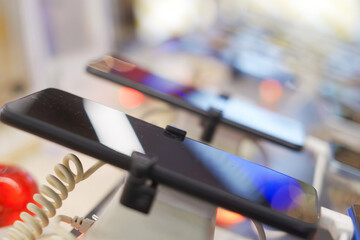 A lot of smartphone models on display at the exhibition stand of an electronics store