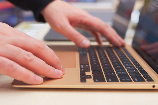 Male hands on laptop keyboard