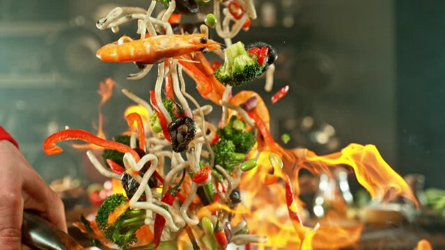Super Slow Motion of Flying Asian Noodles with Vegetable and Prawns. Camera Moving around, placed on High Speed Cine bot. Filmed on High Speed Cinema Camera, 1000 fps. Speed Ramp Effect.