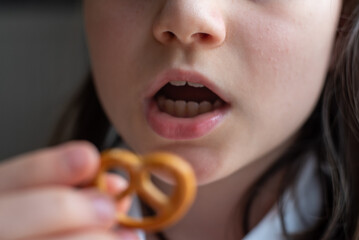 Girl Eating German Pretzel: Close-Up