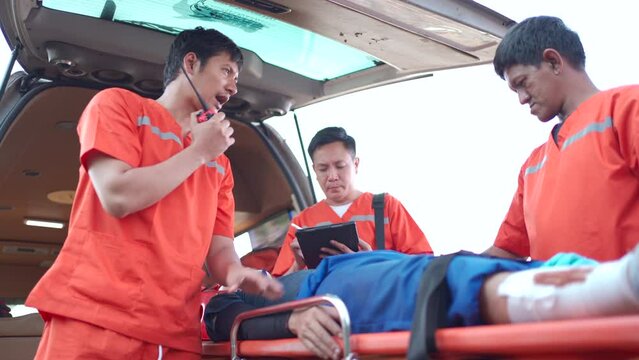 mobility emergency medical service team is rescuing Asian young man.