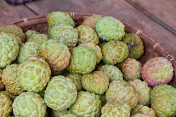 Group of ripe custard apple fruit in bamboo tray