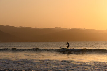 Fototapeta premium SUP boarding lesson on the Mediterranean sea in winter at sunset 2