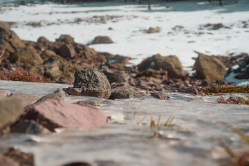 A collection of rocks in an icy river