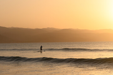 SUP boarding lesson on the Mediterranean sea in winter at sunset 5