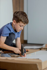 Little Boy assembling furniture. Furniture repair and assembly