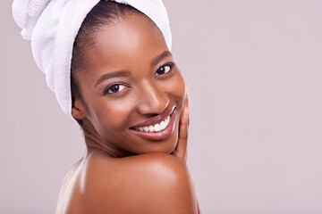 Hair towel, portrait and happy black woman in studio for skincare, wellness or body care on purple...