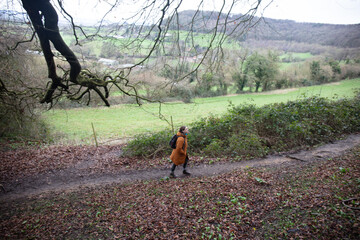 One woman walking in a footpath in the woodland