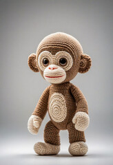 Cute little monkey handmade toy on simple background. Amigurumi toy making, knitting, hobby