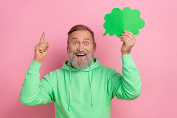 Photo of funky excited man wear green sweatshirt pointing finger rising mind cloud empty space...