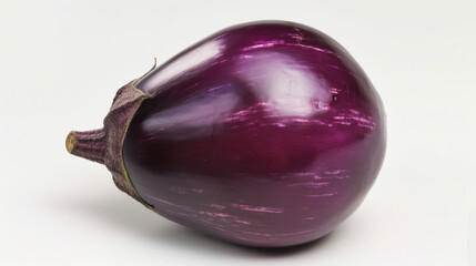 A macro shot of a purple eggplant with its smooth and glossy skin reflecting the light. Its plump and round shape is a testament to its healthy growth and the vibrant color