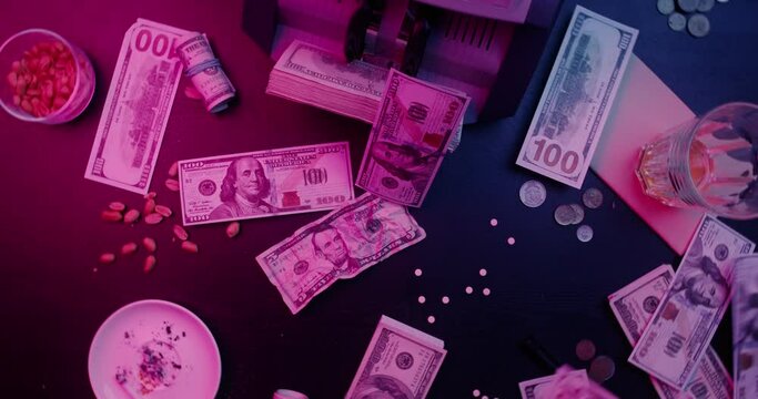 A crumpled five-dollar bill lies on the table of the mafia in front of the calculating machine, hundred-dollar bills fall on the table