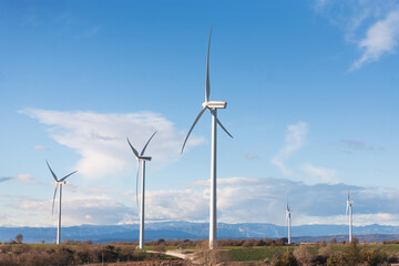 Fototapeta premium view with wind farm with the Pyrenees mountains in the background