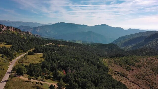 Road and landscape in mountains reveals country house near Figols. Drone flight