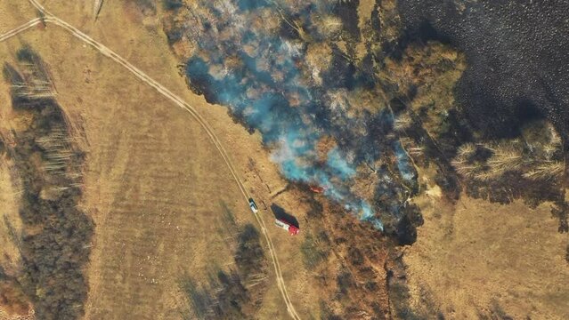 Aerial View. Spring Dry Grass Burns During Drought Hot Weather. Bush Fire And Smoke In Meadow Field. Wild Open Fire Destroys Grass. Nature In Danger. Ecological Problem Air Pollution. Natural Disaster
