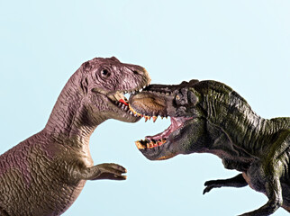 Two dinosaurs on blue background.