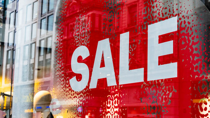 Large Sale sign in white and red in a retail shop window
