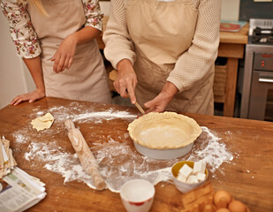 Hands, senior and baking cake in kitchen for bakery with flour, eggs and dessert for Easter weekend. Chef, woman and grandma teaching girl on table with ingredients for cookies, snacks and food