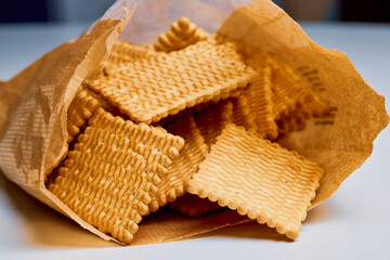 petit beurre biscuits, in a paper bag on a table.