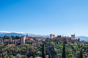 Panorama view of the Alhambra in Granada on a clear Spring day, a palace and fortress complex that remains one of the most famous monuments of Islamic architecture. - 747970805