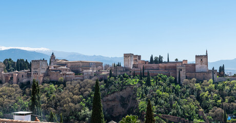 Fototapeta na wymiar Panorama view of the Alhambra in Granada on a clear Spring day, a palace and fortress complex that remains one of the most famous monuments of Islamic architecture.