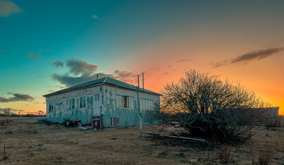 Deteriorated ranch house on a beautiful sunset