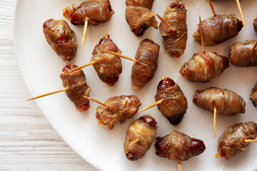 Homemade Bacon Wrapped Dates on a Plate, top view. Close-up.