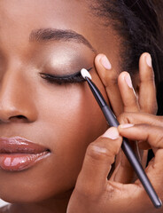 Closeup of black woman, brush and eyeshadow with makeup, beauty and lashes with eyeliner. Skin...