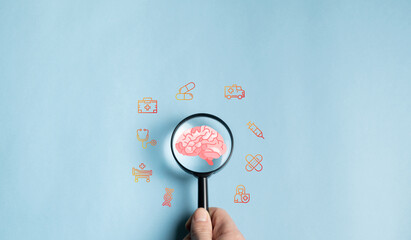 Magnifying glass focuses on human brain icon, prevention, health care or awareness of Alzheimer's,...