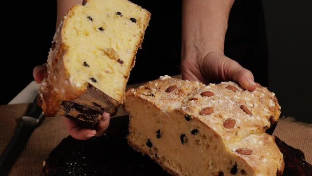 COLOMBA cake is a traditional Italian Easter dessert. The chef breaks the Easter colomba cake in two and shows the delicate and airy pastry. Front view