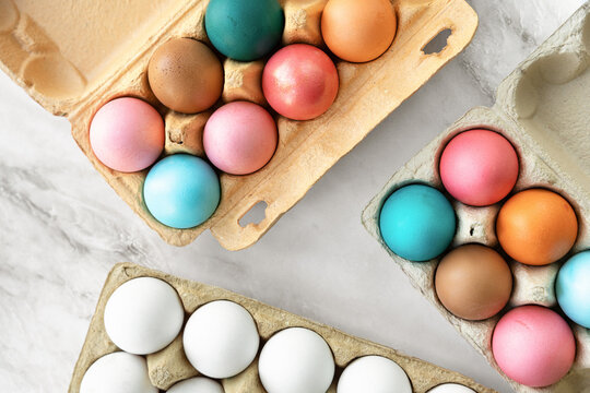 Multi-colored Easter chicken eggs lie on table. close-up, flat lay. top view