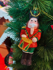 Christmas nutcracker toy soldier hang on the branches of a Christmas tree to celebrate Merry Christmas and Happy New Year.