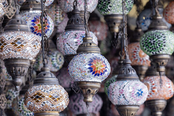 Traditional vintage Variety of Turkish lamps on sale on the market. Exquisite glass lamps and lanterns in Istanbul, Turkey. Beautiful colorful Turkish lanterns hanging in souvenir shop.