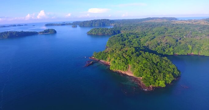 Monohull sailboats anchored in a calm water bay off shore from Parida Island in an archipelago in Panama