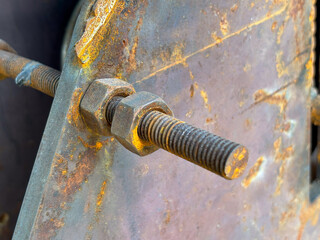 Close-up of a rusty bolt and nut on aged metal equipment