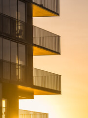 Golden Sunrise Illuminating Balconies of a Modern Building in Gothenburg, Sweden.