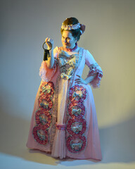 cinematic  portrait of female model wearing an opulent pink gown,  costume of a historical French baroque nobility, style of Marie Antoinette. Holding ring of keys,  Isolated on  studio background