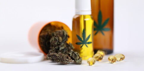 On table marijuana in jar and hemp oil in capsules. Help for cancer patients. Medical cannabis...