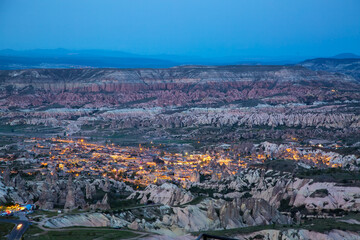 Fototapeta na wymiar Aerial view of Goreme City at twilight evening sunset in Cappadocia, Turkiye.