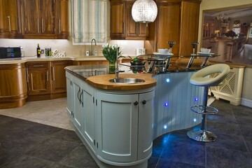 Contemporary kitchen with island in modern style with extractor fan kitchen with lamp. Wood doors.