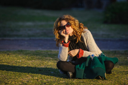 Close voew of woman sitting on the grass in a park