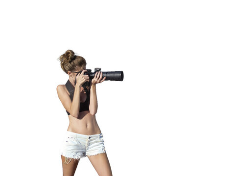 A young woman taking a picture with long lens isolated against white background