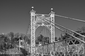 Queens Park Suspension Bridge 1923 footbridge crossing the river Dee at the Groves in Chester, Cheshire, England, UK in black and white - 748013210