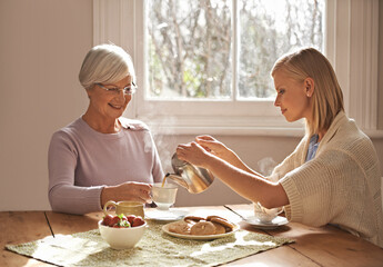 Happy, grandmother and woman with tea in home for brunch, bonding or visit in retirement. Senior,...