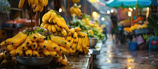 A collection of fresh yellow bananas arranged neatly on a wooden table. The bananas are vibrant in color and ready to be enjoyed as a healthy snack. - obrazy, fototapety, plakaty