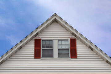 Gable end windows with fixed decorative shutters of a house in Boston, MA, USA